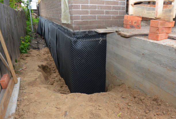 Happy homeowners after waterproofing job in Benton